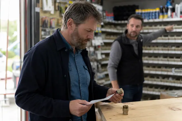Client préparant une commande de matériaux dans une quincaillerie rurale.