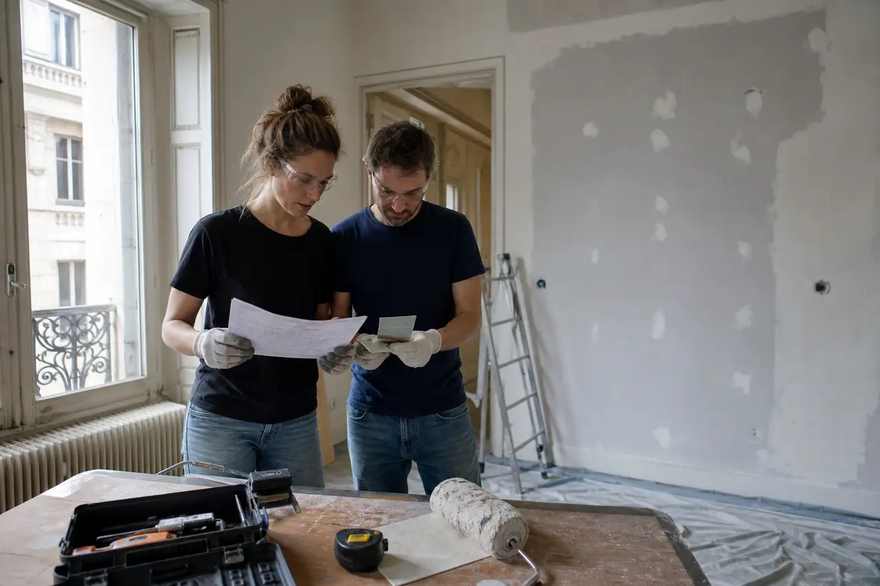 Couple planifiant des travaux légers dans un appartement en rénovation.